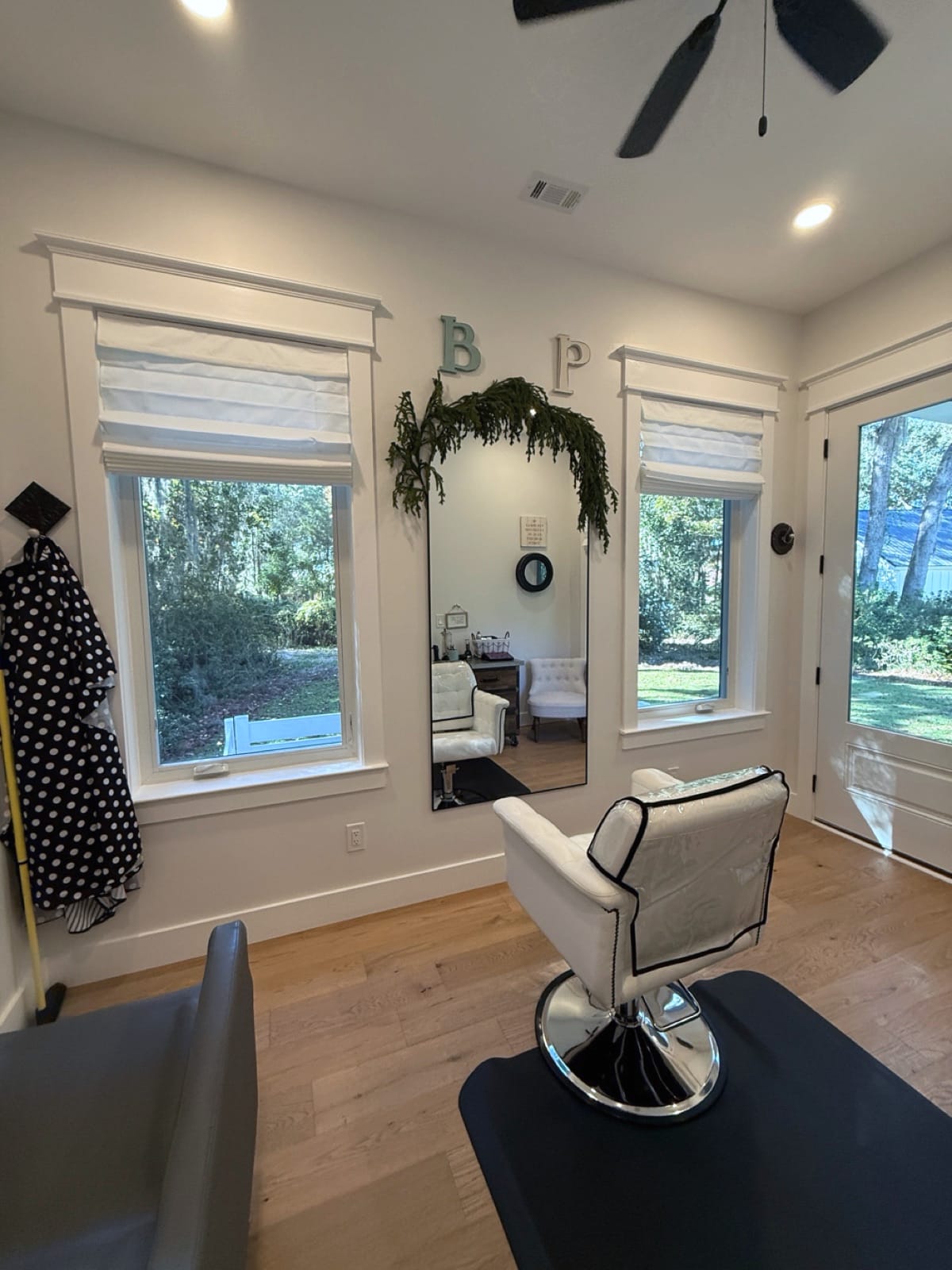 Salon mirror with B and P monogram letters and garden views