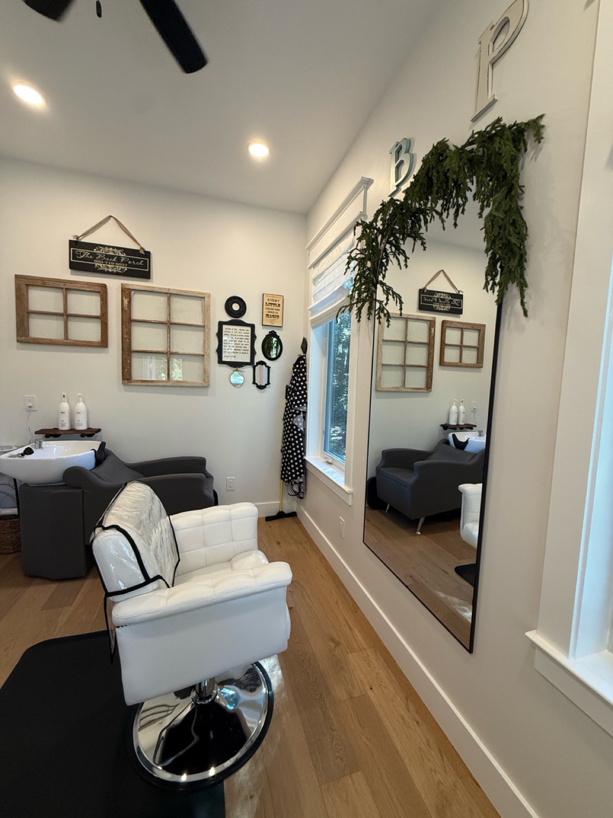Styling chair and shampoo station in the bright white studio
