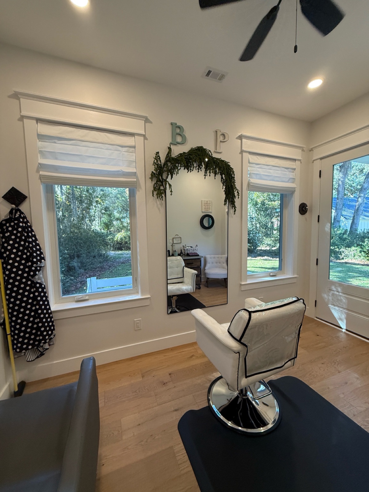 Salon mirror with B and P monogram letters and garden views